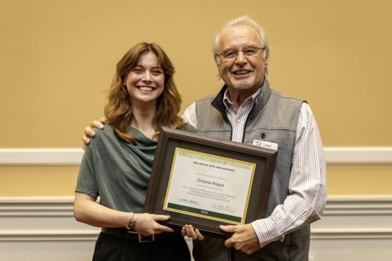 John Kopchick and Octavia Hogue hold the award