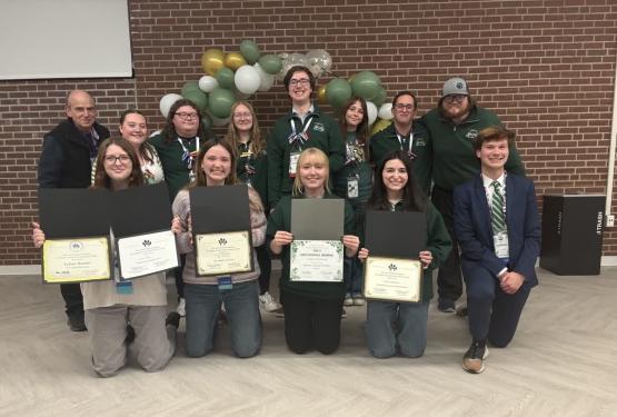 OHIO students and staff from Housing and Residence Life pose for a group photo while holding their awards