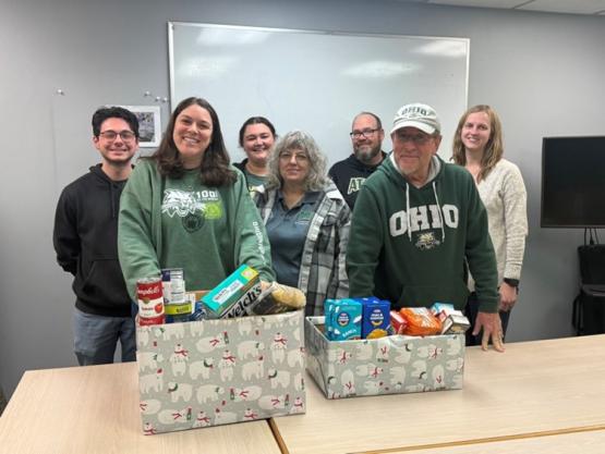 OHIO employees stand by boxes of food collected in the food drive