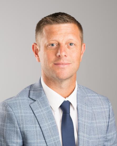 A professional headshot of Dustin Kilgour. 