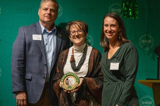 OHIO representatives stand with Lynn Harter, who is holding her award
