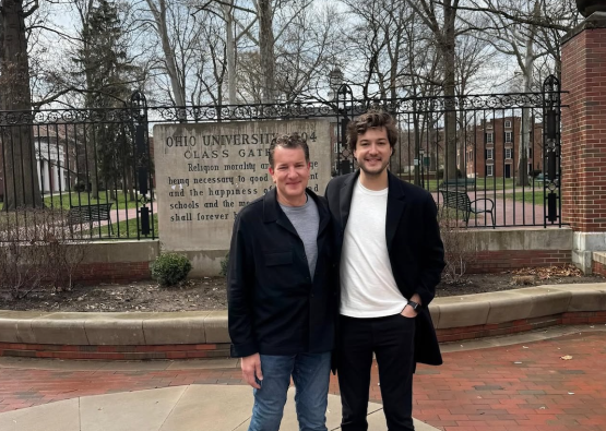 Father and son pose for a photo