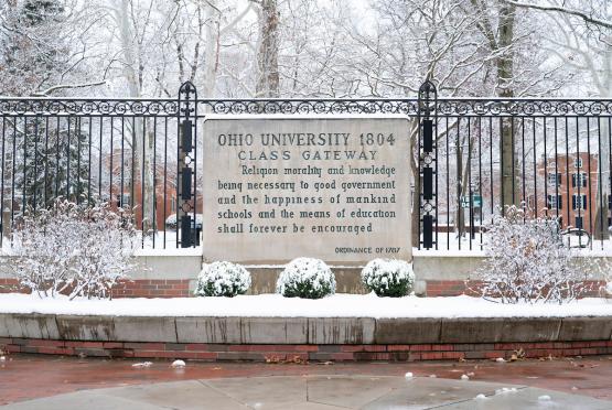 The Class Gateway is covered in snow, and the College Green is shown behind it, also covered in snow