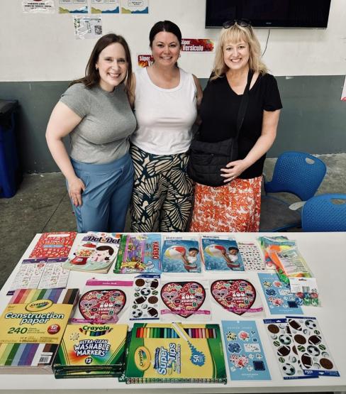 Three Ohio University representatives stand in front of a table filled with art supplies while in Costa Rica