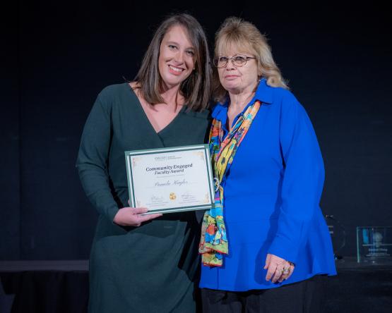 Courtney Lefebvre and Pamela Kaylor hold the award