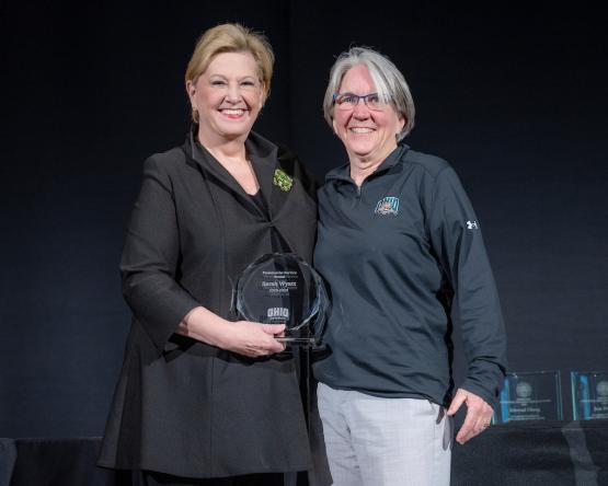 President Gonzalez and Sarah Wyatt hold the award