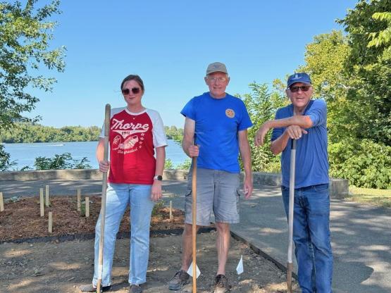 Sarah Simmons stands outside with two other Rotary Club members as they work on a service project