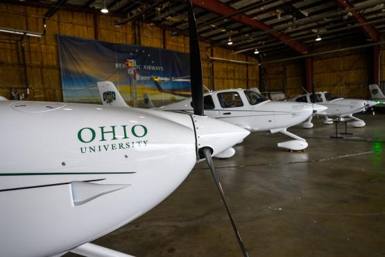 Airplanes with OHIO logos on them are shown inside the hangar at the Gordon K. Bush Airport