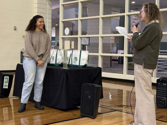 Lyn Redington presents an award to an OHIO administrator at the event in the Ping Recreation Center