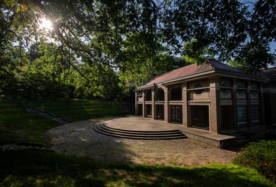 Scripps Hall is shown surrounded by green grass and trees on a summer day