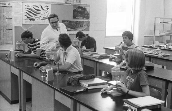 A black and white photo of students and a professor in an OHIO Lancaster classroom many years ago