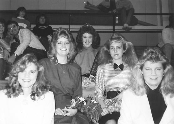 The members of the OHIO Lancaster Homecoming Court sit together on bleachers in this image  from 1986