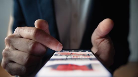 An up-close image of someone scrolling on a social media platform.
