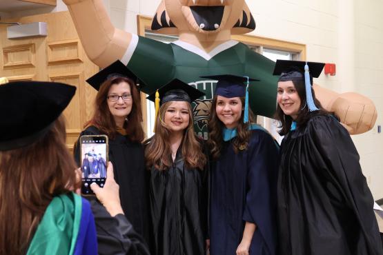 Jennifer Kellner-Muscar stands with students and faculty after the Graduation Recognition Ceremony