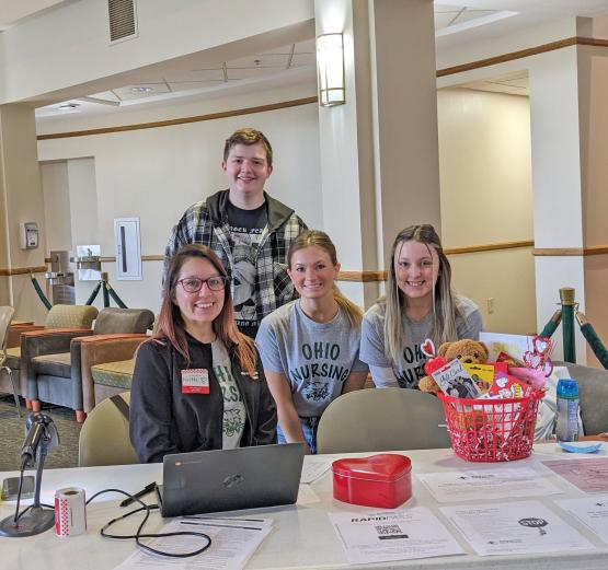 student nurses sit behind registration table at blood drive