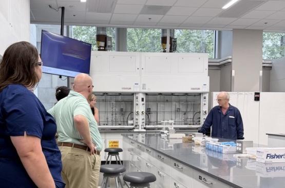 OHIO employees are shown talking in a laboratory in the Chemistry Building