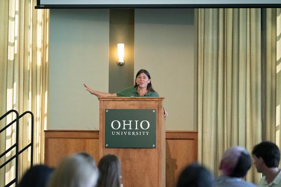 Dean Tracy Plouck speaks at the podium during the Welcome Reception