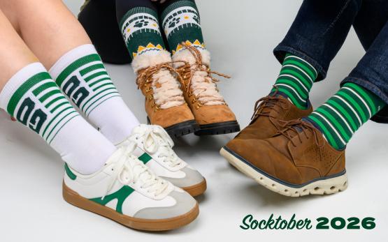 The image shows three people wearing different Socktober socks and the words "Socktober 2026"