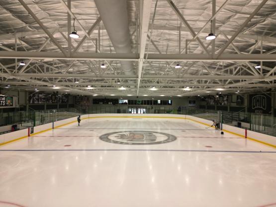 The new ice is shown inside of Bird Arena. Two people are shown skating on the ice in the background.