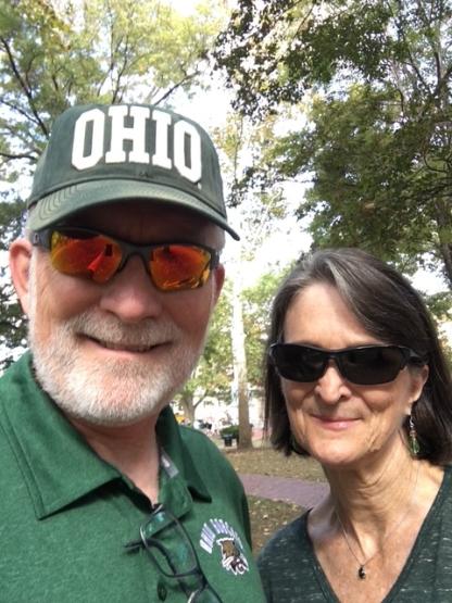 David Crane is shown with his wife and he is wearing a hat that says "OHIO"