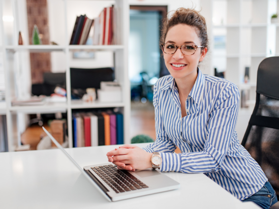 woman sitting at a desk with a computer