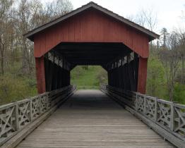 Shaeffer Campbell Covered Bridge, A covered bridge painted red, the photo shows the wooden decking that flows through the covered bridge