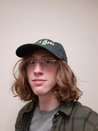 Evan Johnson, wearing a green baseball hat