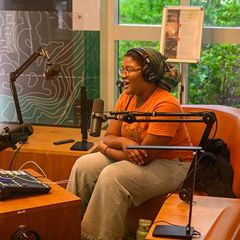 A student works in the Scripps Podcast lab.