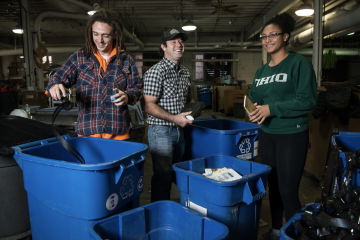 From left, Abraham Kitchen, Andrew Ladd, and Vanessa Thiel sort recyclables at Ohio University's Campus Recycling center on November 15, 2016.