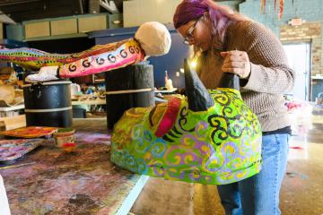 Artist Logan Madison works on a piece for the 2019 Honey for the Heart parade. Photo by Alaina Bartel
