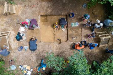 Aerial image of students and faculty with the Archaelogical Field School at a dig site