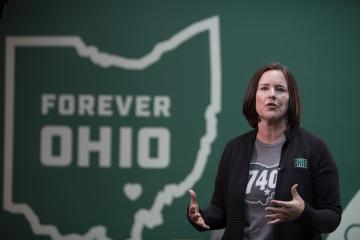 Jenny Hall-Jones speaks at the Leadership Awards ceremony in front of a graphic of the state of Ohio with the words Forever OHIO