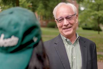 Ohio University President Hugh Sherman, who is featured on the cover of the fall 2021 issue of Ohio Today magazine, is pictured with a student on College Green.
