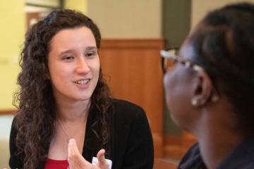 Two women talking in the college of business