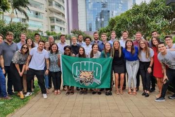 Students holding an OHIO flag while on a trip to Brazil