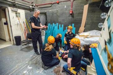 Jeff Russell works with students during an emergency simulation