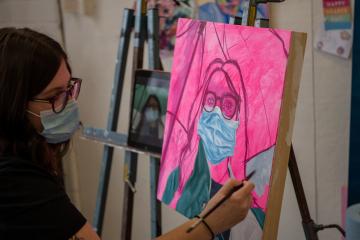 Abigail Pennington is shown working on one of her paintings