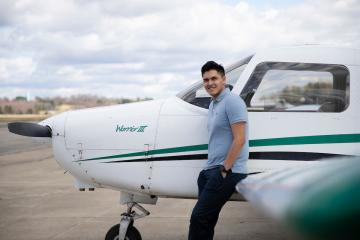 Johan Mendez poses with a Piper Warrior III