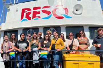 Students pose on the deck of the RESQ ship in Sicily