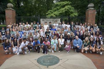High school students and undergraduate students pose for a group picture on Ohio University's campus