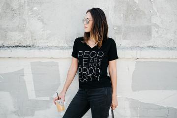 Person wearing a black T-shirt stating people are not property