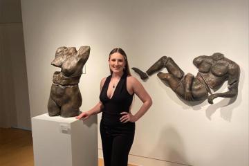 Ceramics Student Jade Lewis with her thesis work in Trisolini Gallery, spring 2022