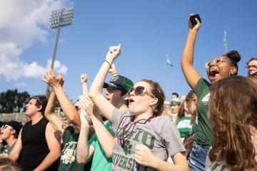 Ohio University fans stand up and cheer during the Homecoming 2021 football game at Peden Stadium.