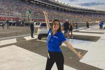 Ohio University student Sam Spinale poses in front of Charlotte Motor Speedway during internship. 