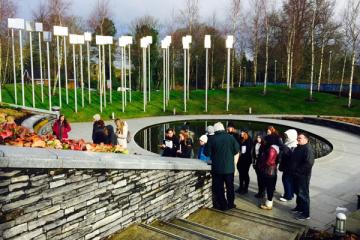 Students visit the Omagh bombing memorial site with Michael Gallagher, chairperson of the Omagh Self Help and Support Group. Gallagher advocates nationally and internationally for a public inquiry into the bombing.