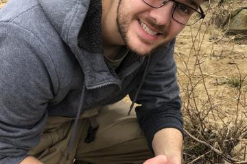 Ryan Wagner with a mudpuppy salamander.