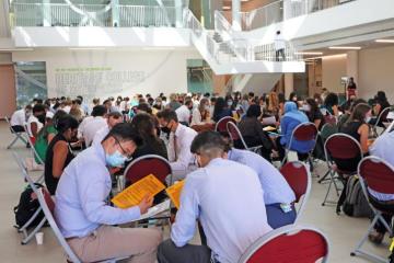 Students sitting in groups at workshop