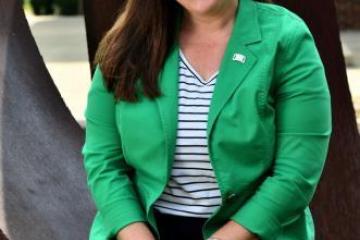 Photo of Stacy Schindler smiling, in a green blazer