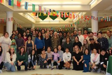 Students and staff members pose for a photo at the Global Education Fair at Athens High School