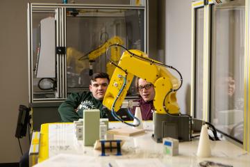 Two students work together in a lab, for the automation technician and mechatronics technician programs